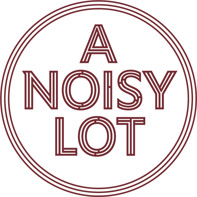 A Noisy
               Lot logo, depicting the rust-red text
               'A Noisy Lot' surrounded by three thin
               concentric rings of the same color.